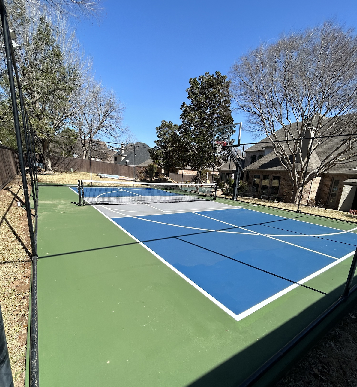 A backyard basketball and pickleball court