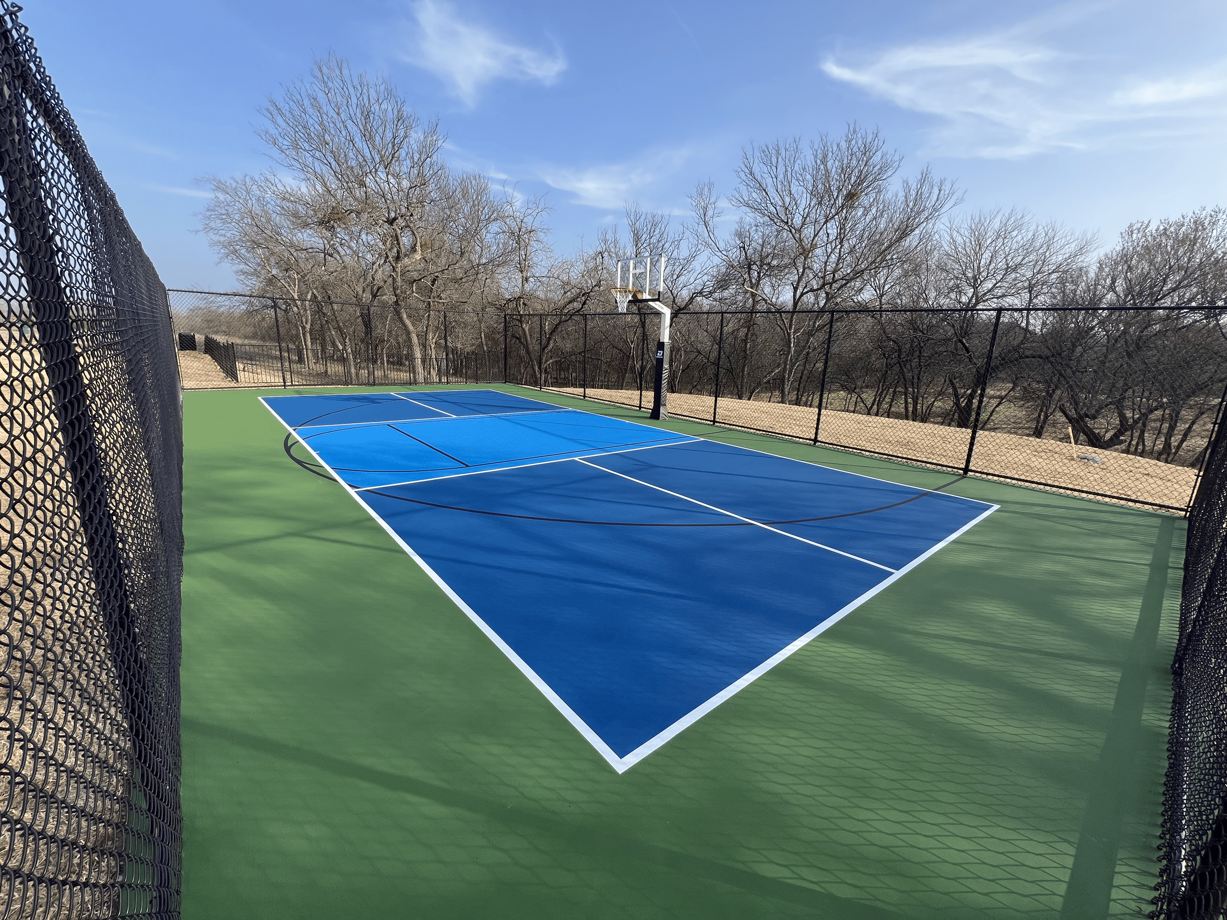 A pickleball paddle and ball on a pickleball court